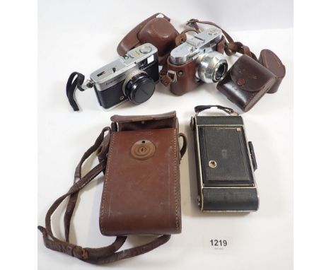 A group of three cameras including Voightlander, Kodak folding camera and Olympus Trip 