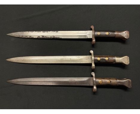 A collection of three Lee Metford bayonets: One maker marked "Sanderson 3/95" with double edged blade 300mm in length, pommel