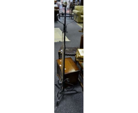 A black painted wrought iron standard lamp