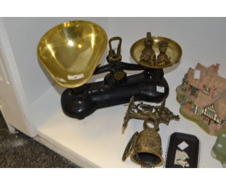 A set of cast iron Libra counter top scales and brass pans, and weights ;  a wall mounting brass bell (2)