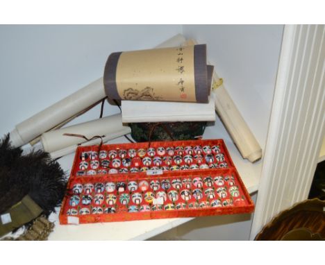 A Chinese theatre mask display; Chinese silk stacking boxes; a hand painted scroll; printed scrolls (6)