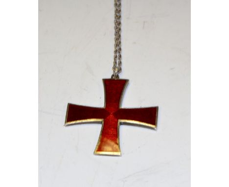 A silver and enamel cross on chain