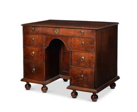 A GEORGE I OAK KNEEHOLE DESK  IN THE MANNER OF SAMUEL PEPYS, CIRCA 1720 74cm high, 94cm wide, 56cm deep      Condition Report