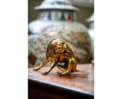 A BRONZE MODEL OF A DOG  NUREMBERG, LATE 16TH CENTURY   Modelled seated, turning, tongue lolling  9cm high, base 10cm wide   