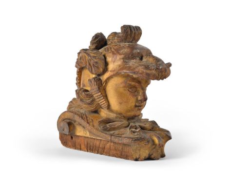 A CARVED AND GILTWOOD BOAT PROW FINIAL  18TH CENTURY  Possibly French, the face beneath elaborate scrolling plumed helm  25cm