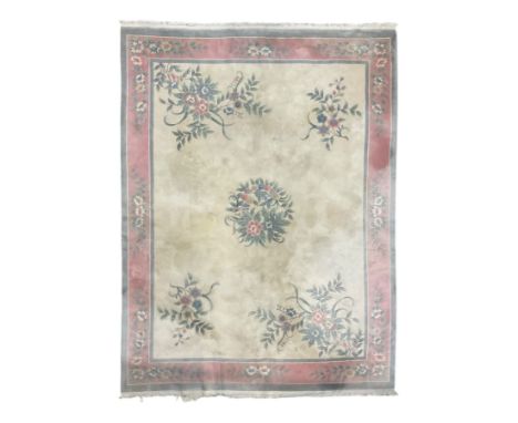 Chinese ivory ground washed woollen carpet, the field decorated with five large floral motifs with extending leafage, the wid