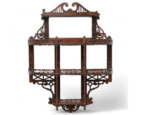 Early 20th century fretwork wall mirror shelf, swan neck pediment over four tiers and bevelled mirror plates, decorated with 