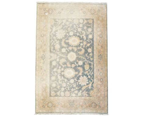 Indo-Persian indigo ground carpet, the field decorated with large palmette motifs connected by scrolling foliate, enclosed nu