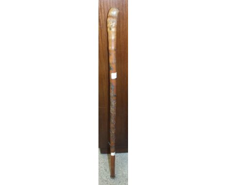 An Oriental carved bamboo walking stick, 86.5cm long.