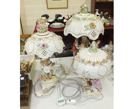 A 20th century Continental porcelain two-piece table lamp having four dancing children around a central column, on scrolled b