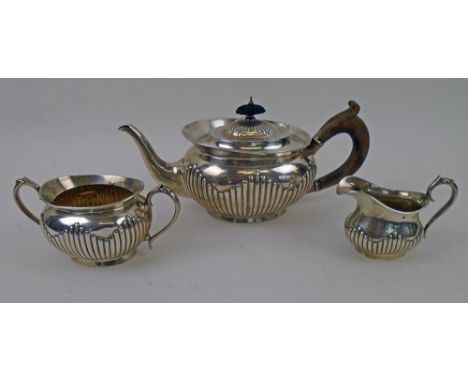 SILVER TEA SERVICE, Victorian, comprising a teapot, sugar bowl, and cream jug, part gadrooned design, London 1895, makers Wil