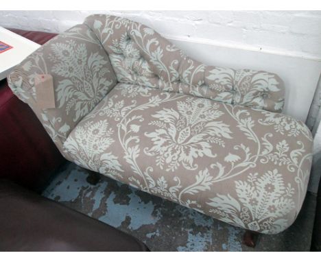 CHAISE LONGUE, button back in floral fabric on ball and claw supports.