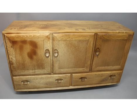 ERCOL SIDEBOARD a light elm sideboard with a two door cupboard and smaller cupboard with cutlery tray. With two long drawers 