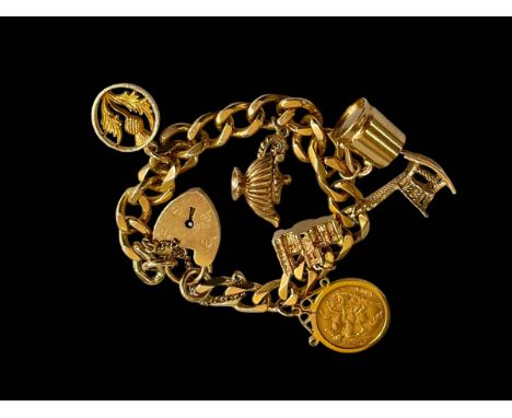 9 carat gold charm bracelet with five charms and 1914 half sovereign.