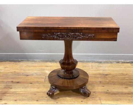 A rosewood card table, second quarter of the 19th century, the foldover and revolving top opening to a blue baize-lined playi