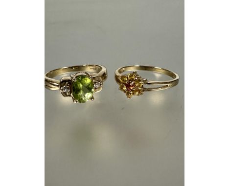 A 9ct gold citrine cluster ring O and a 9ct gold peridot ring and paste set ring N/O 5.31g (2)&nbsp;