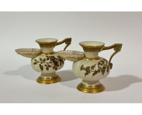 A pair of 19thc Royal Worcester ivory jugs with flared spout, ribbed body, gilt and thistle leaf decoration to body. (h- 14.5