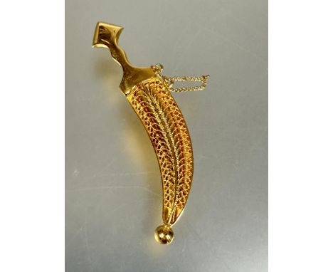 A Middle Eastern yellow metal Jambiya brooch with filigree scabbard and safety chain L x 5.7cm no signs of damage or repairs 