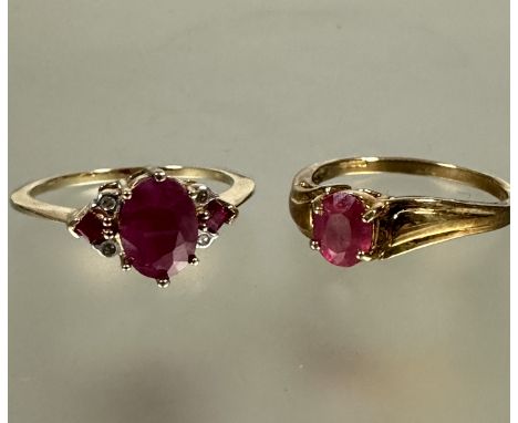 A 9ct gold solitaire ring set pink oval ruby mounted in four claw setting O approximately 0.30ct and a 9ct gold three stone r