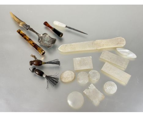 A collection of nine 19thc Chinese shell gaming tokens, an oval carved panel and paper knife all with figures characters et c