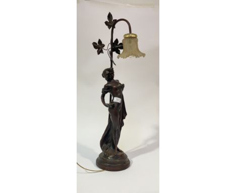 An Art Nouveau cast bronzed metal figural table lamp, with glass shade H75cm.