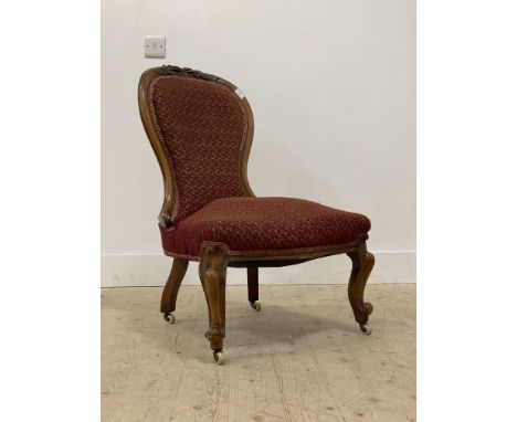 A Victorian walnut upholstered spoon back slipper chair, standing on cabriole front supports with ceramic castors. H90cm.