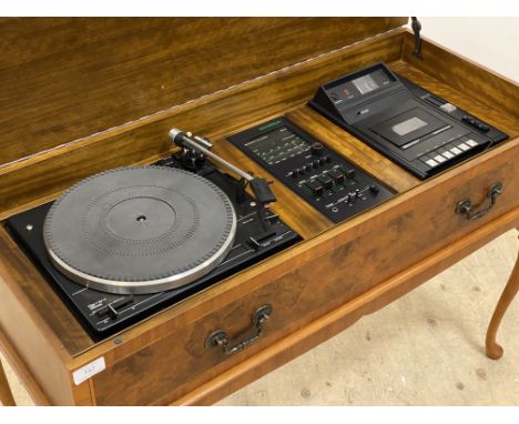 A cross banded burr walnut radiogram by Dynatron, the hinged top opening to a Gerrard 35SB record player and a Dolby cassette