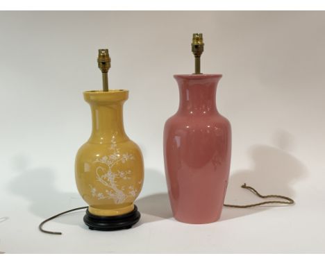 A pink ceramic baluster shaped table lamp (h-45.5cm) and a ceramic mustard coloured baluster shaped table lamp with a tree an