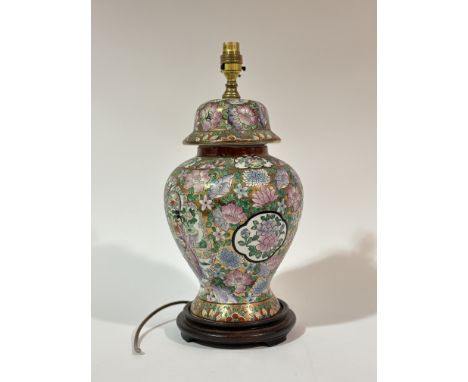 A modern Chinese Famille rose style on gold background baluster shaped table lamp raised on a circular wooden base. (h-42cm)