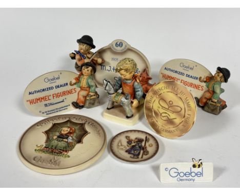 A collection of Hummel shop display signs including 1935-199, authorized dealer, Goebel , Collectors club member, a miniature