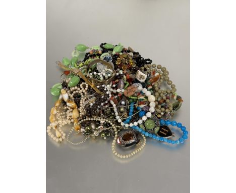 A collection of costume jewellery to include bead necklaces, baste and enamel brooches, paste pearl and moonstone necklaces e