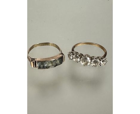 A 8ct gold dress ring set three cushion cut channel set aquamarines, stamped 333 P and a 9ct gold and platinum five clear sto