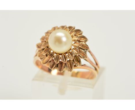 A CULTURED PEARL DRESS RING, designed as a central cultured pearl atop a two tiered leaf design surround to the trifurcated s