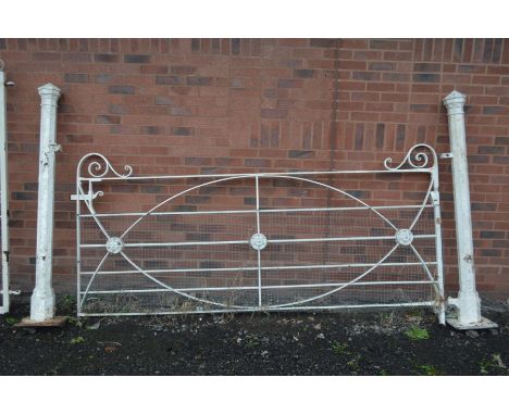 A 19TH CENTURY WROUGHT IRON SIX BAR ESTATE GATE, with ellipitical and rosette decoration with the pair of octagonal gate post