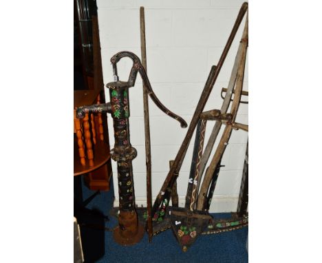 A GYPSY PAINTED CAST IRON WATER PUMP, height 131cm together with a collection of similar painted farming tools (11)