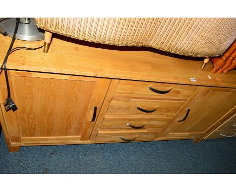 A LIGHT OAK SIDEBOARD with three central drawers, width 160cm x depth 42cm x height 77cm