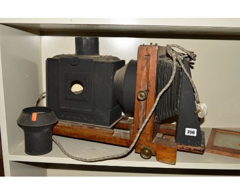 A TINPLATE AND WOOD MAGIC LANTERN, fitted with a Carl Zeiss Jena Tessar 13.5cm f4.5 lens, a standard slide plate and a rotary