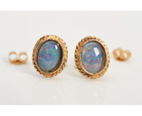 A PAIR OF 9CT GOLD OPAL TRIPLET STUDS, each designed as an oval opal triplet within a collet setting within a collet setting 