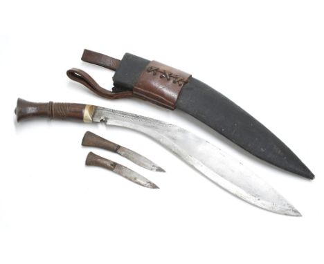 Early 20th Century Burmese Kukri knife, complete with further two small knives in canvas wrapped and leather mounted rigid sc