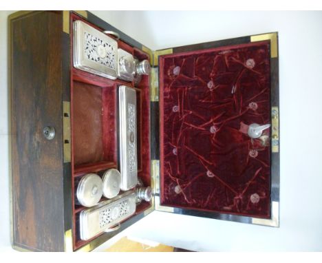 A William IV rosewood vanity box, having lacquered brass re-enforcement and flush fitting flank handles, the hinged lid with 