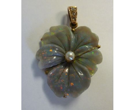 A gold coloured metal and opal leaf pendant, on a diamond set ring