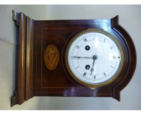 An Edwardian string inlaid mahogany cased bracket clock, having a round arched top, a lacquered brass bezel, straight sides a