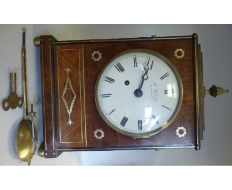 A Regency mahogany cased bracket clock with inlaid brass designs, having a stepped top and straight sides, a pineapple finial