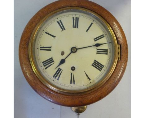 An early 20thC light oak cased dial timepiece, having a turned surround and a brass bezel; the movement faced by a painted st