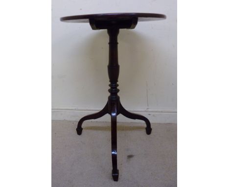 An early 19thC mahogany pedestal table, having a tip-top over a ring turned, baluster column, raised on a tripod base with sp