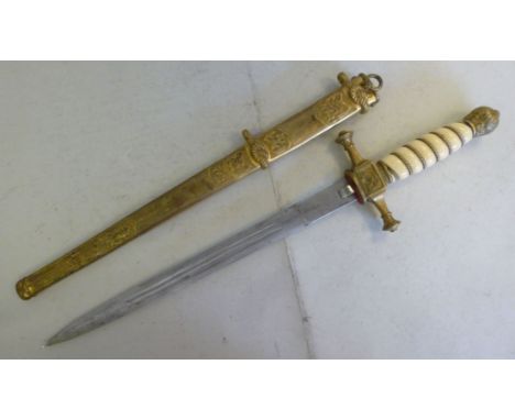 A German Imperial Dirk, having a gilt brass pommel and quillions with a ribbed ivory handle the (possibly Domascus) blade ins