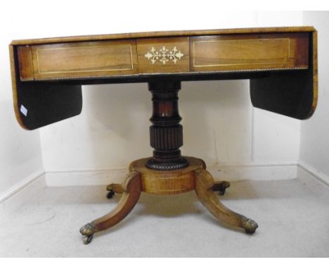 A Regency brass inlaid rosewood sofa table, having two concealed frieze drawers, over a reeded, turned, tapered column with c