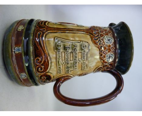 A Doulton Lambeth stoneware water jug of tapered form, having a flared rim and loop handle, produced to celebrate the reign o