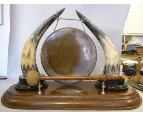 An Edwardian Anglo-Indian table gong with silver plated mounts, featuring a pair of cattle horns, suspending a circular plate