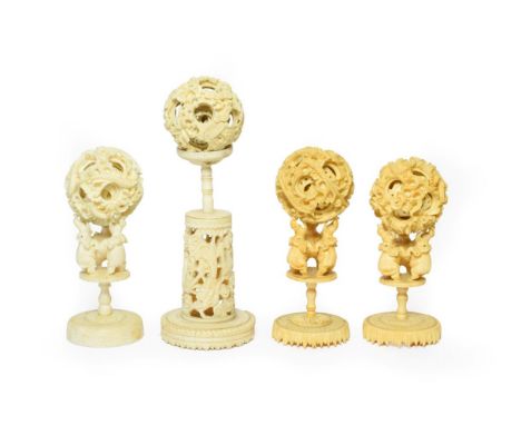 A Cantonese Ivory Puzzle Ball, 19th century, on a carved and pierced column stand, 19cm high overall; A Similar Pair of Puzzl